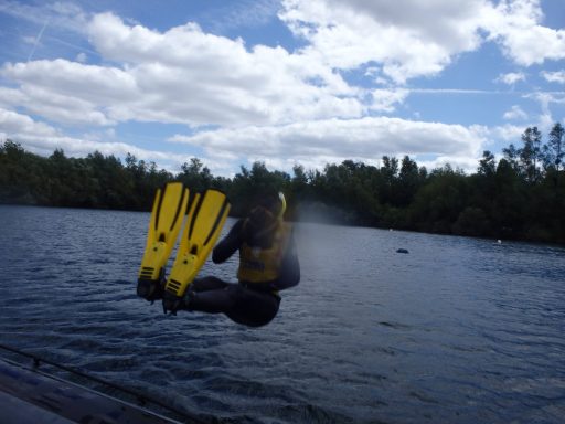 Snorkeller completing backward entry into lake